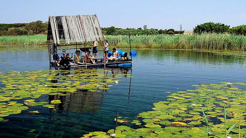 Divers kitting up on the thatched deck over the spring