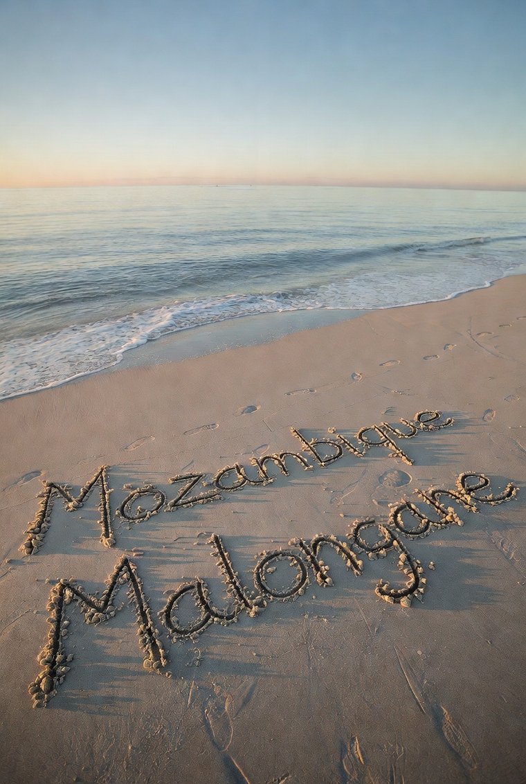 Mozambique Malongane written in the sand at sunrise